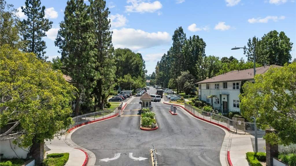 Aerial view of a curving tree-lined entrance road