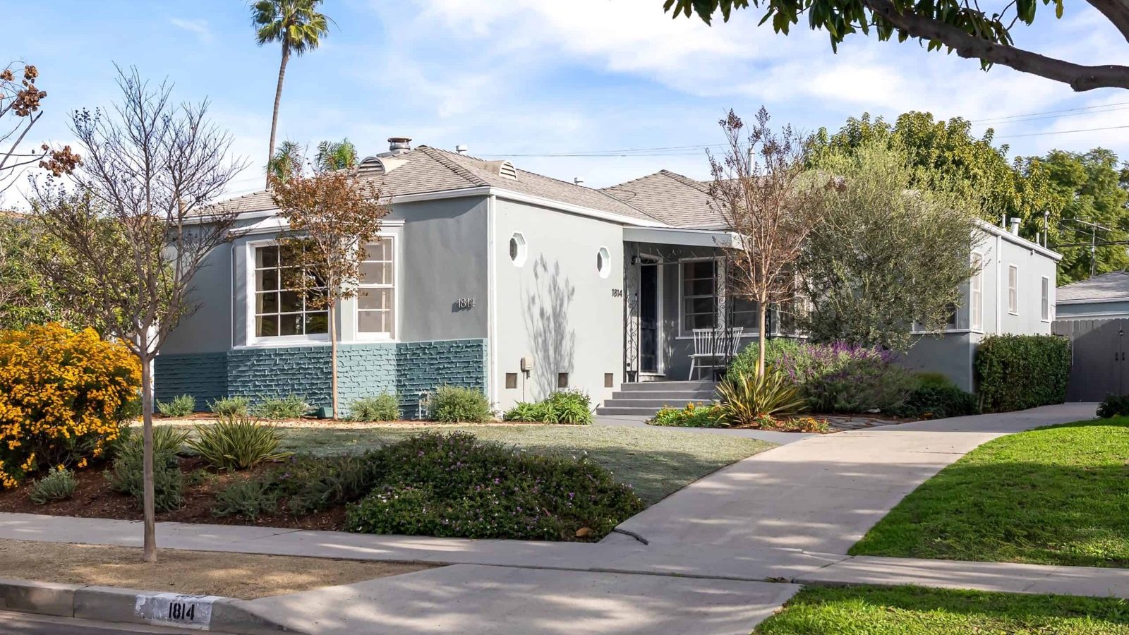 Gray single-story house with a landscaped front yard